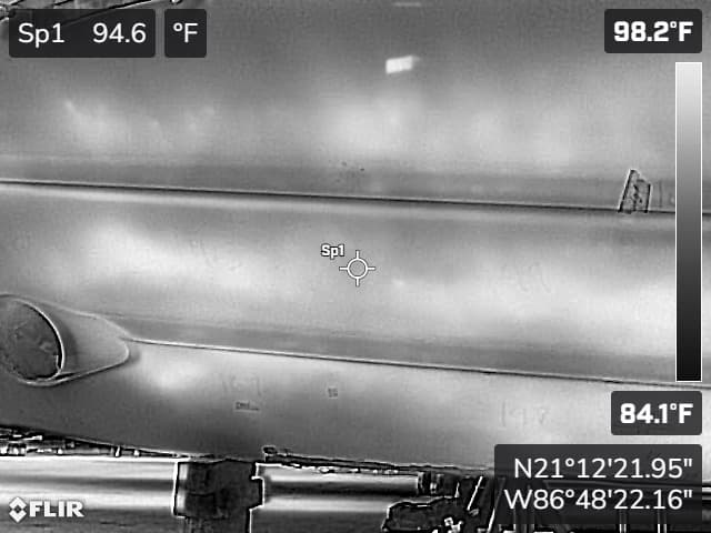 Port bow hull damage documented with measurement scale