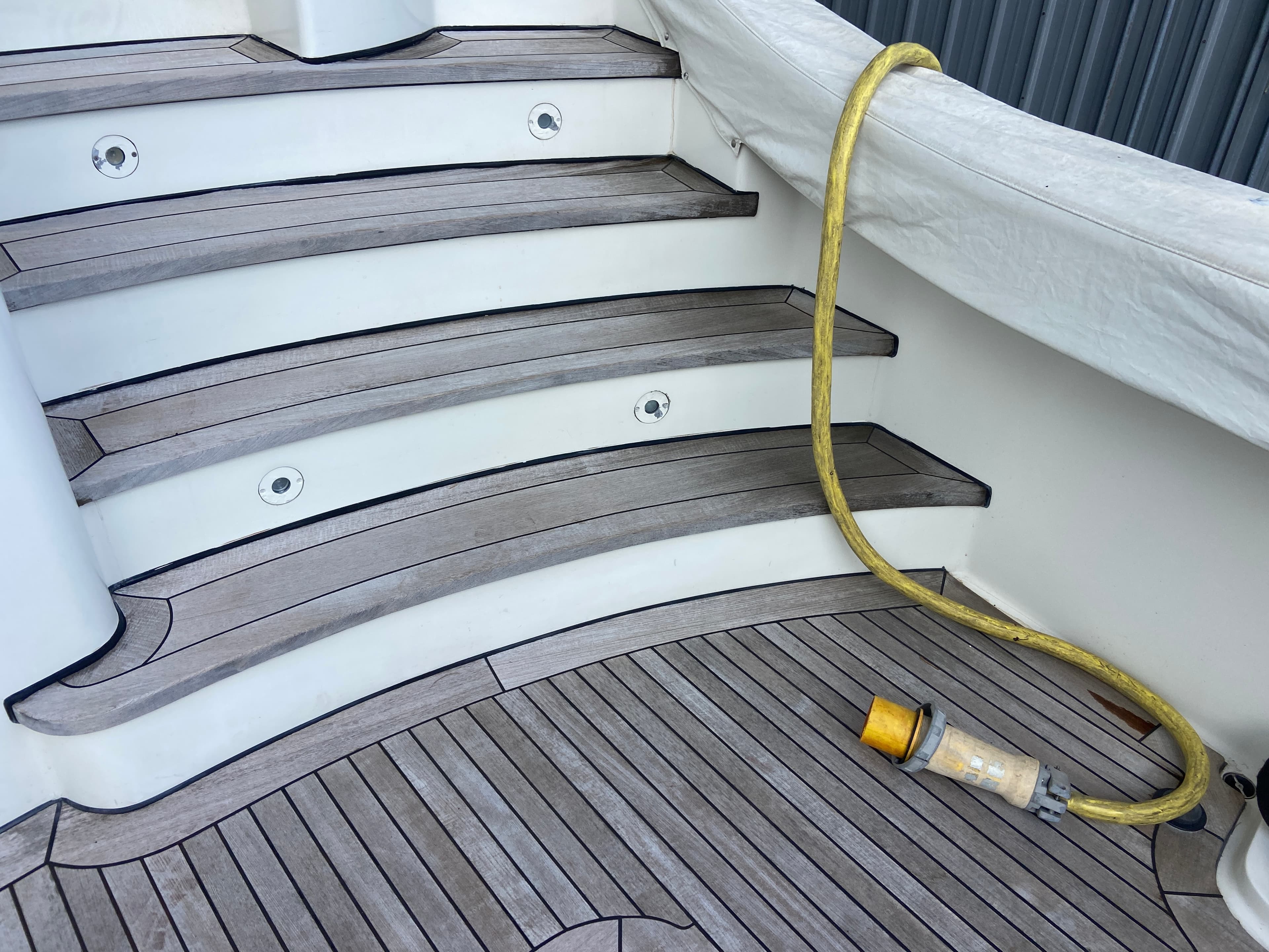 Moisture meter showing elevated reading on white hull surface